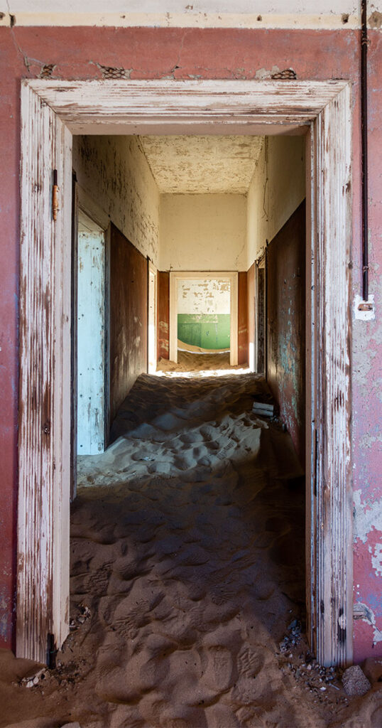 a view of a sandy hallway from a pink room